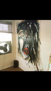 a room with a painting on the wall and a tv